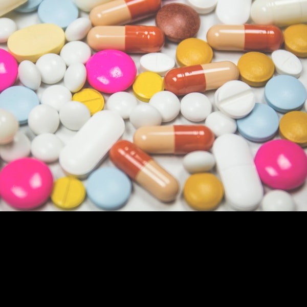 Generic blue medication tablet on white background