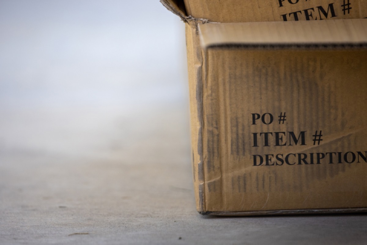 A parcel being handed over at a doorstep